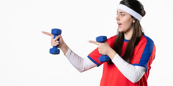 front view young female sport clothes working out with dumbbells white wall
